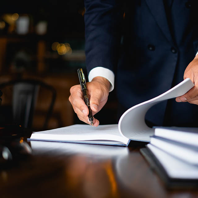 Close up lawyer businessman working or reading lawbook in office workplace for consultant lawyer concept.