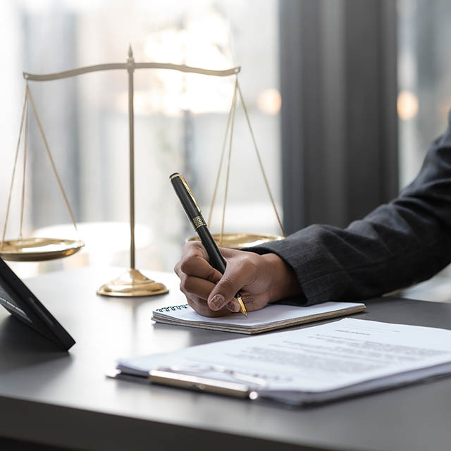 A lawyer is preparing documents for his client to sign.