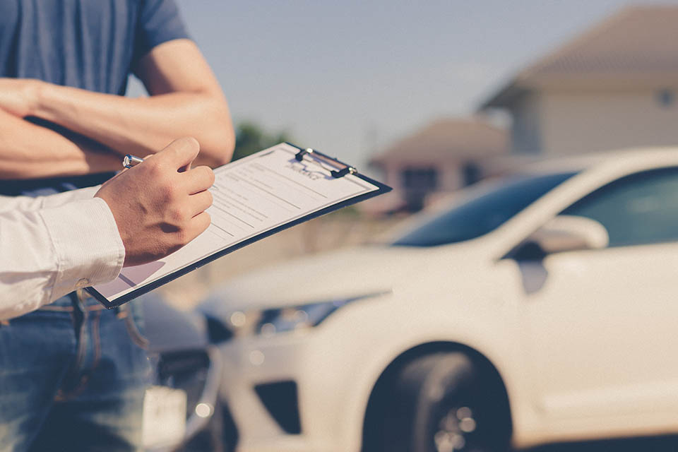 Insurance agents inspect for damage to cars that collide on the road to claim compensation from driving accidents, Insurance concept.